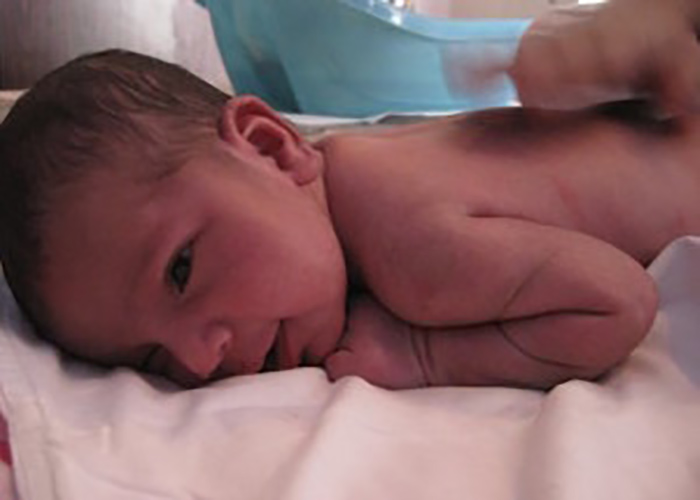 Baby massage on a newborn baby